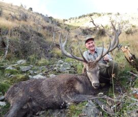 Henrik with huge red stag beside his wallow